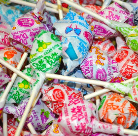 Assorted Dum Dum Original Pops flavors showcased in a candy buffet setting.
