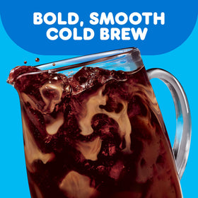 Two Dunkin’ Cold Brew pouches steep in water for batch brew.