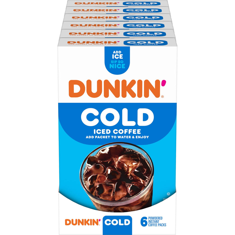 Dunkin Cold instant coffee packets beside a glass of iced coffee for quick refreshment.