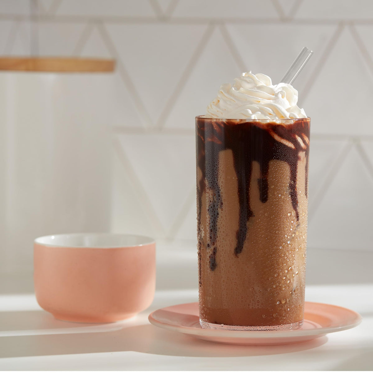 Dunkin Cold instant coffee packets on a kitchen counter with ice.
