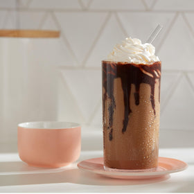 Dunkin Cold instant coffee packets on a kitchen counter with ice.