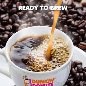 Dunkin' Donuts Dunkin Dark K-Cup pods stacked on table for quick daily coffee.