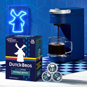 Dutch Bros coconut mocha pod in a Keurig brewer producing a steaming cup.
