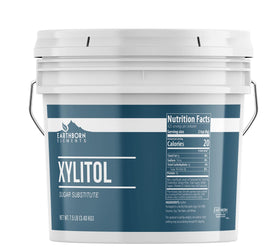 Earthborn Elements Xylitol bulk bucket on counter, ideal for baking and everyday sweetening.