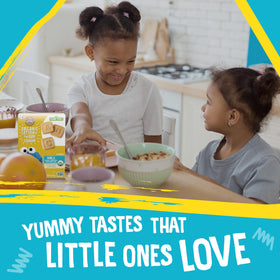 A toddler enjoys Earth's Best vanilla cookies with yogurt.