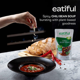 EATIFUL Chili Soup served in a bowl with spoon, hearty vegetables and beans.