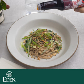 Eden buckwheat soba plated with toppings highlighting earthy flavor.