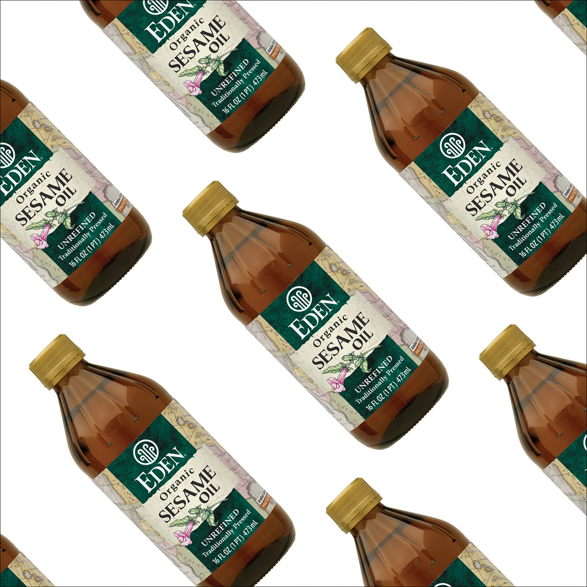 Glass bottle of Eden Sesame Oil rests on kitchen shelf.