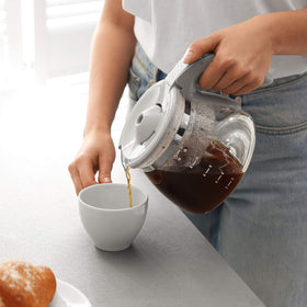 Eight O'Clock Hazelnut ground coffee cup with steaming aroma.