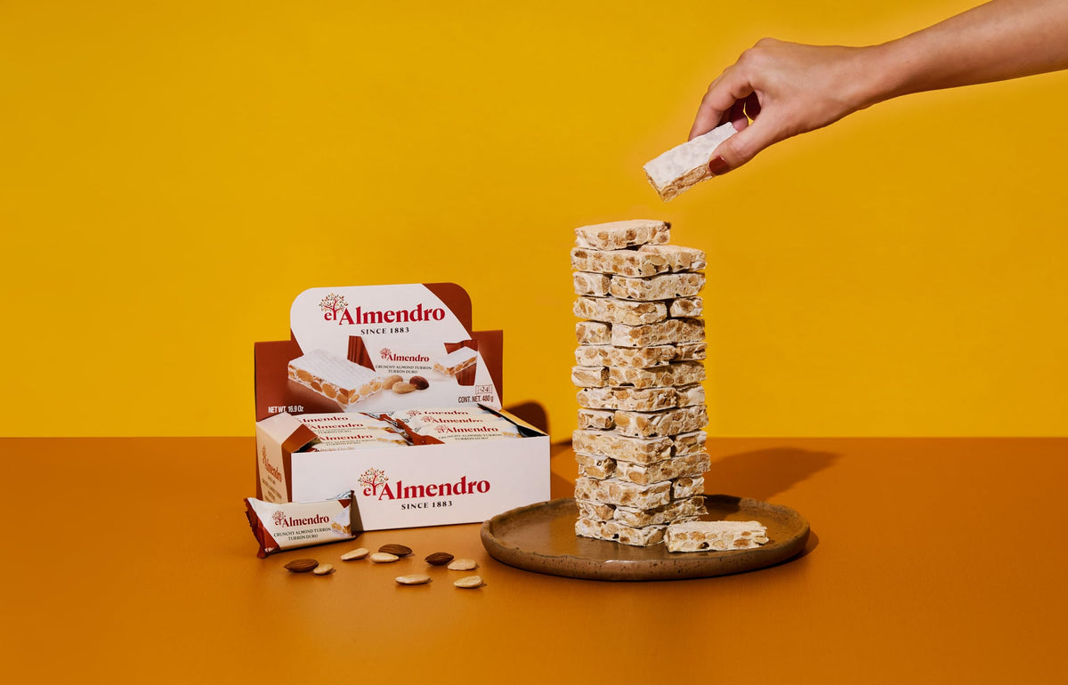 El Almendro Crunchy Almond Turron bar close-up shows almonds and texture.
