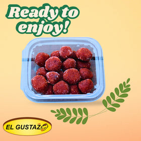 El Gustazo Tamarind Balls served on plate with friends.