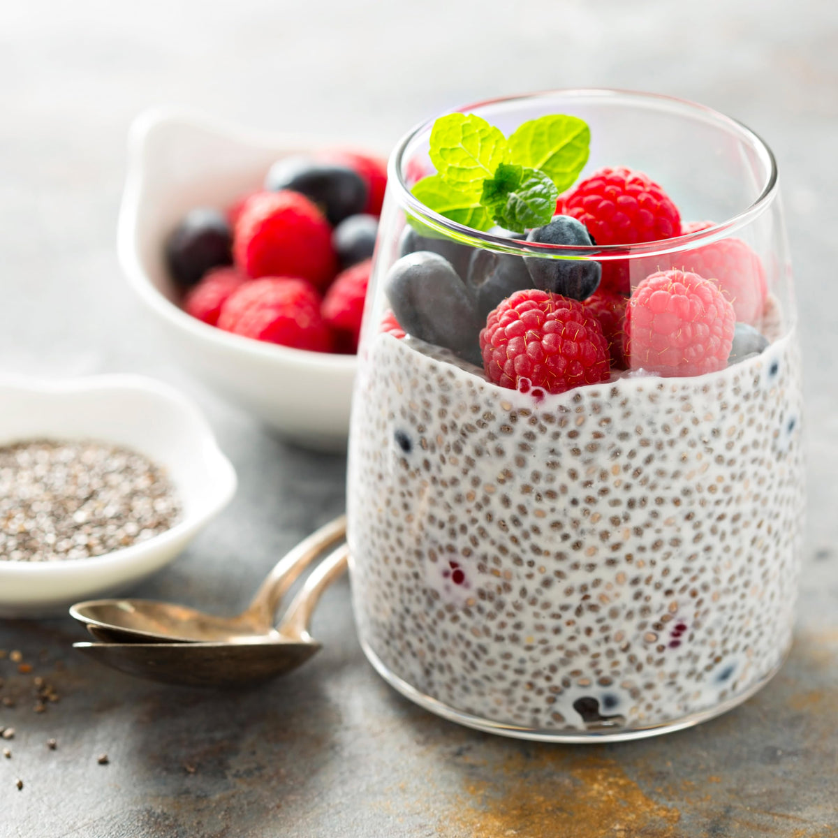 Elan chia seeds pouring over oats, perfect for overnight breakfast recipes.