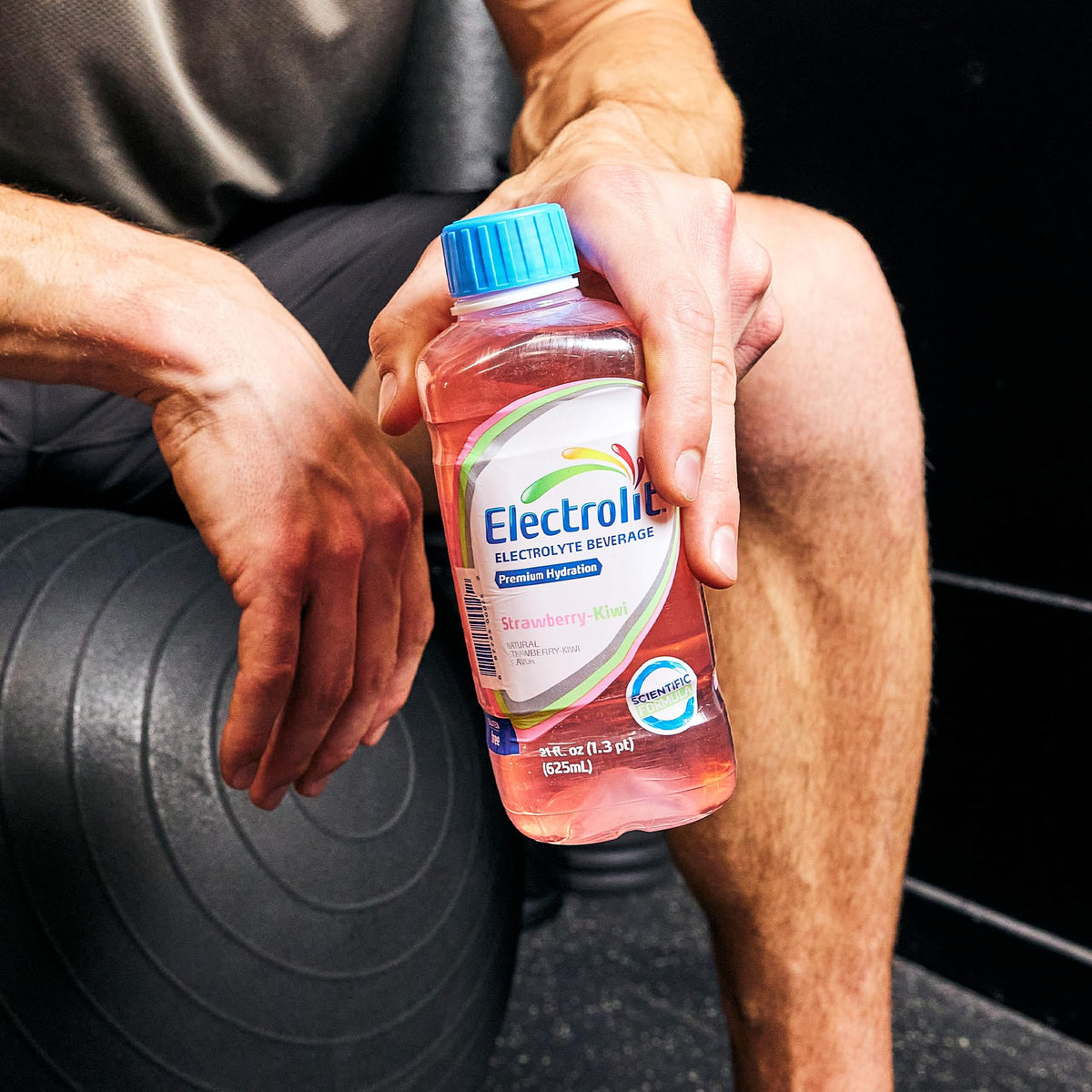 Electrolit Strawberry-Kiwi 12-pack on a shelf for family trips.