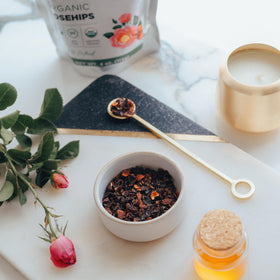 Elanen Naturals steaming cup rosehips infusion, soothing aroma to savor.