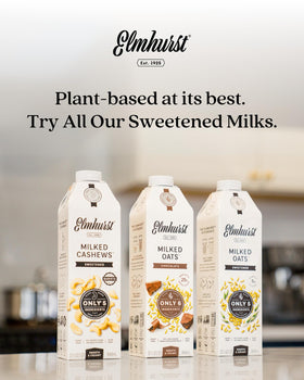 Chilled glass of Elmhurst 1925 oat milk, dairy-free and sweetened.