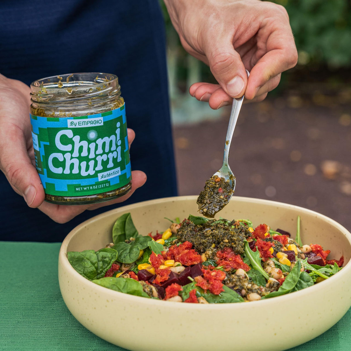 EMPACHO Chimichurri sauce being poured over steak for bold Argentine flavor