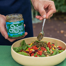EMPACHO Chimichurri sauce being poured over steak for bold Argentine flavor