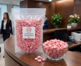 Emporium Candy Pink Wintergreen Mints discs closeup, showcasing a crunchy texture