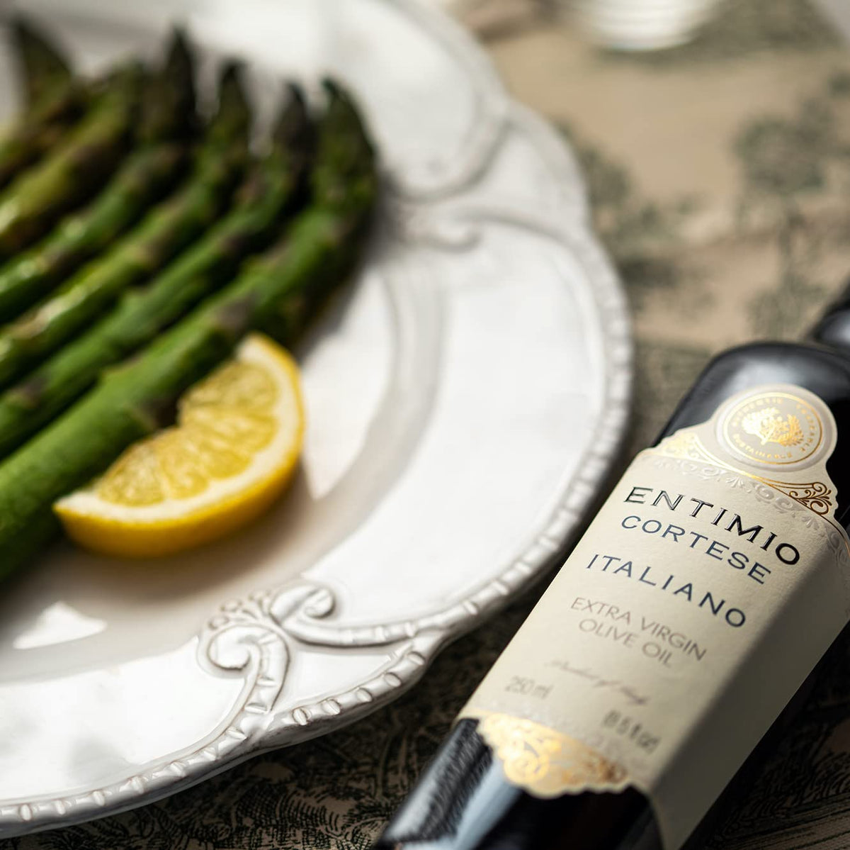 Entimio bottle pour action illustrating smooth, peppery finish in cooking