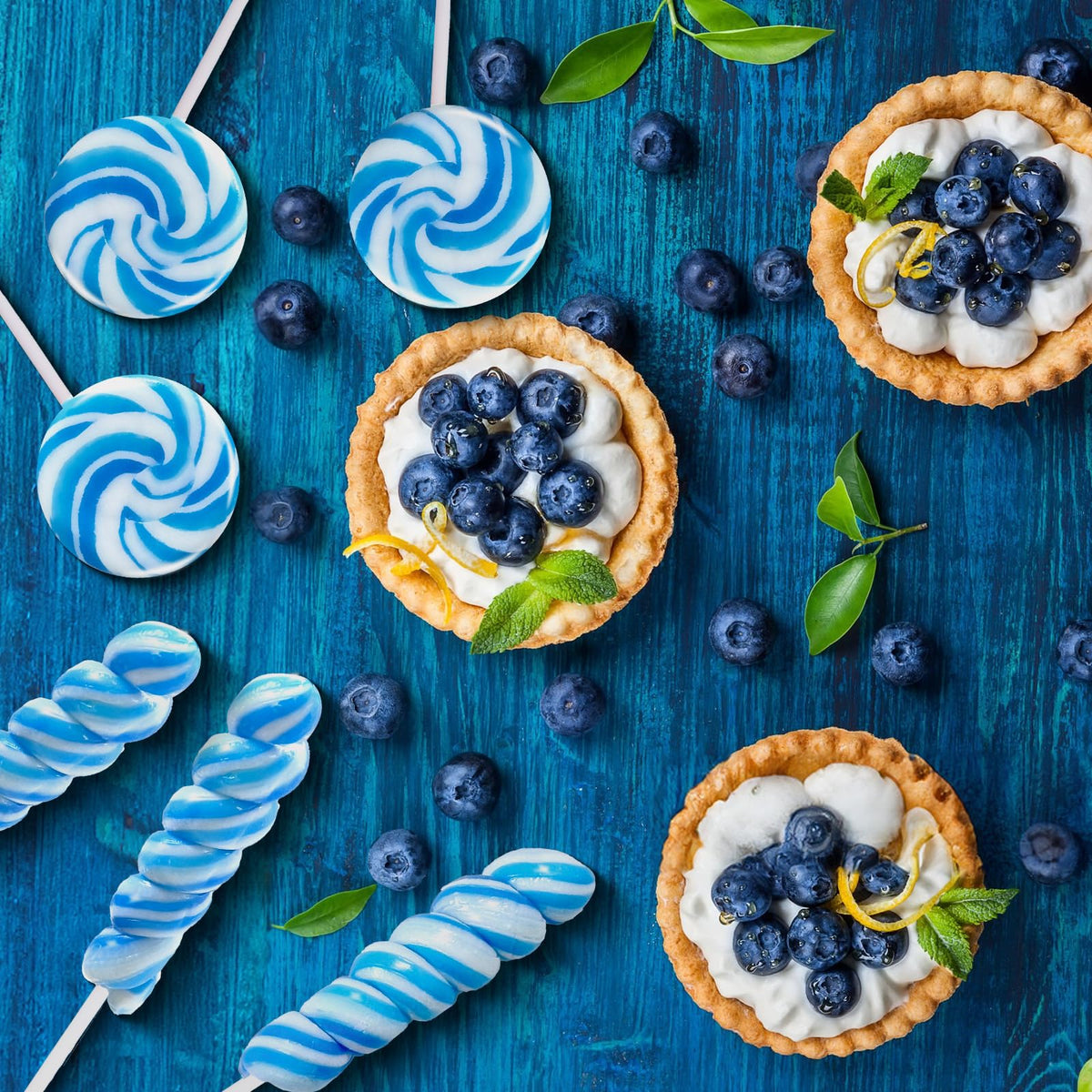 EORA Something Blue wedding candy table uses blue lollipops for chic treats.