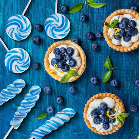 EORA Something Blue wedding candy table uses blue lollipops for chic treats.