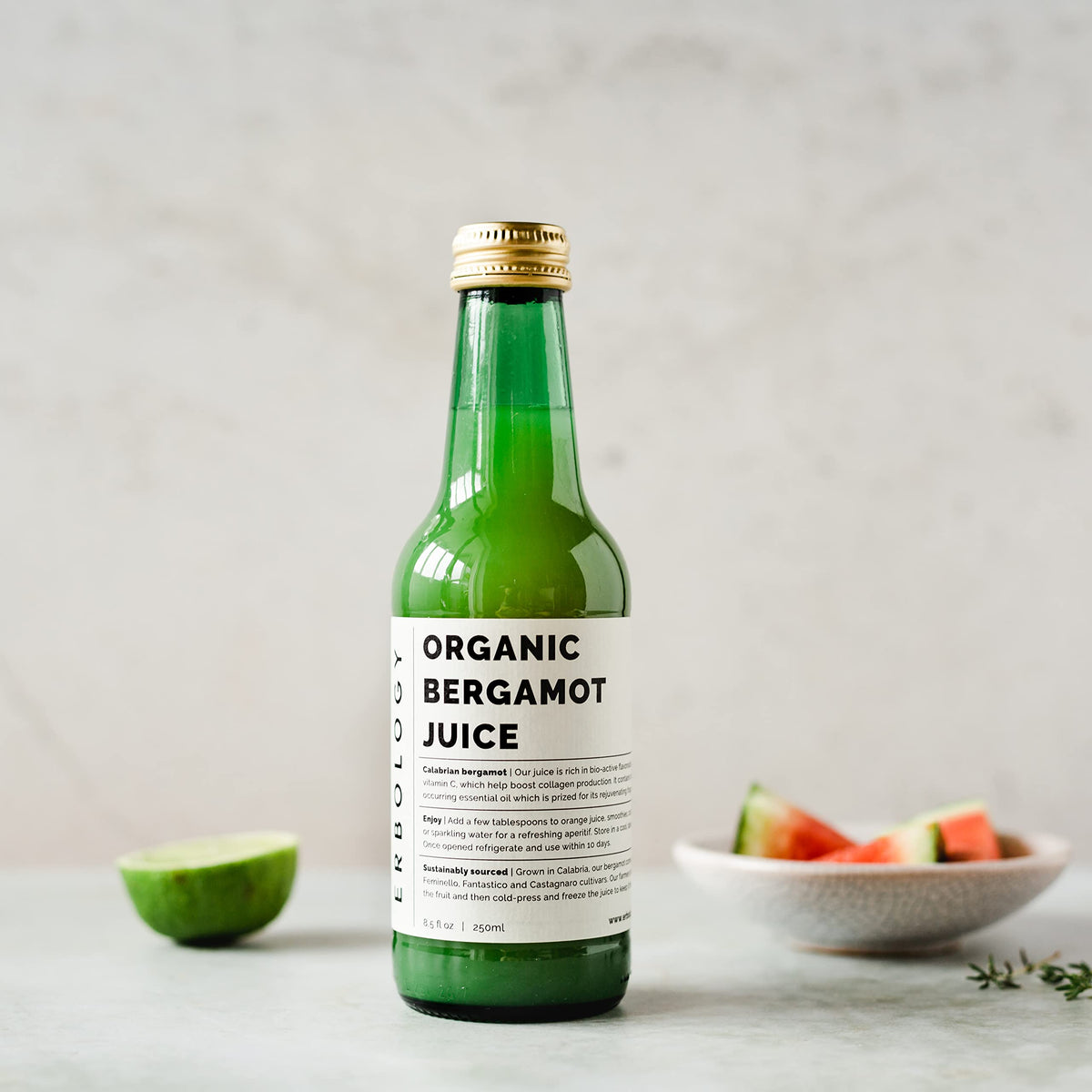 Erbology bergamot juice pour glass captures vibrant citrus flavor ready to refresh.