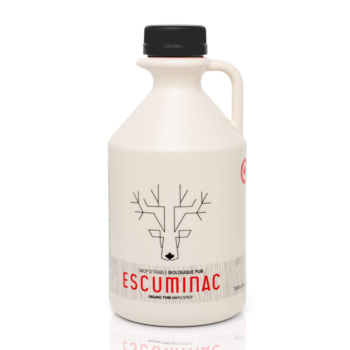 Escuminac maple syrup bottle drizzled over pancakes for breakfast sweetness.