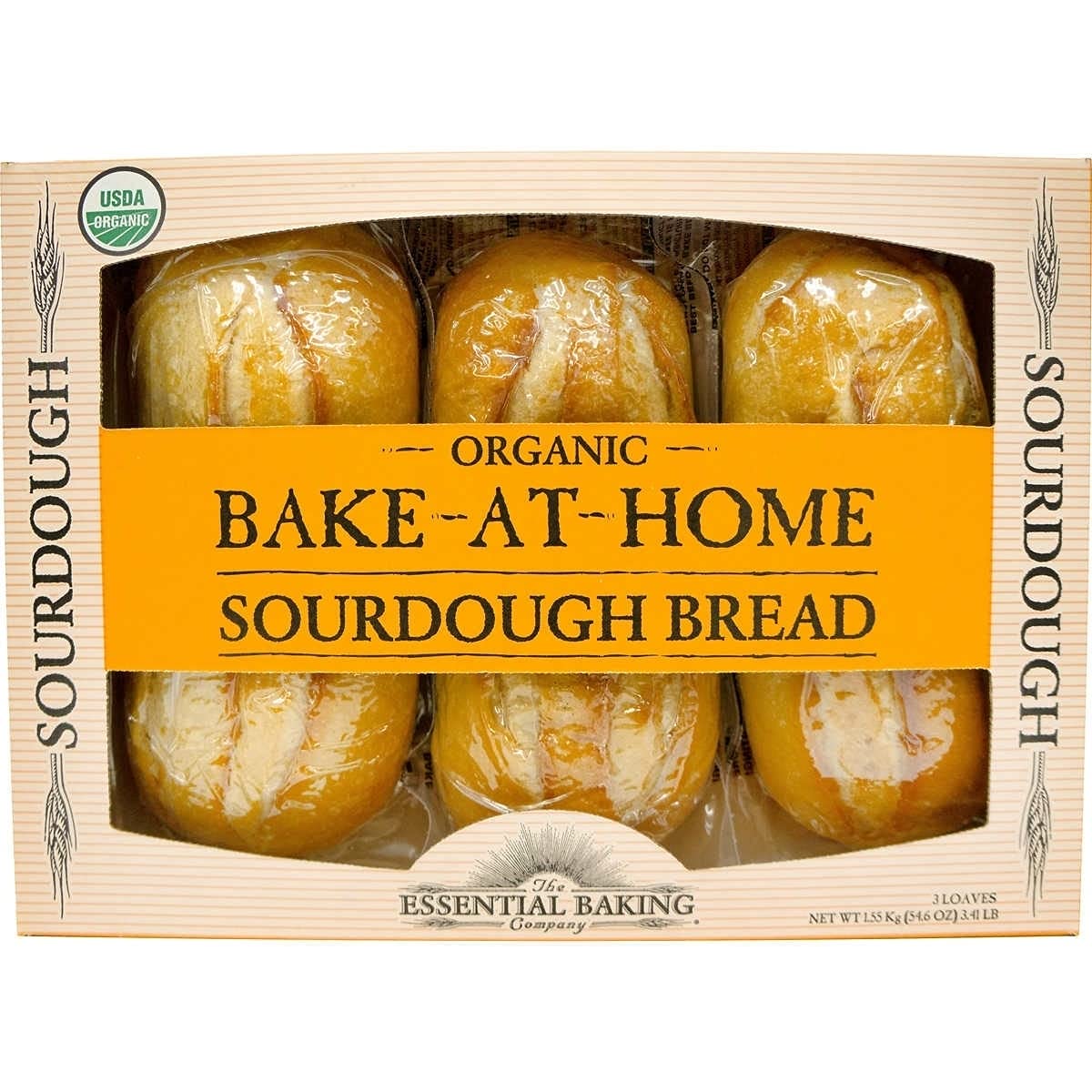Essential Baking Company Organic Sourdough loaves on a wooden board ready for slicing and dipping.
