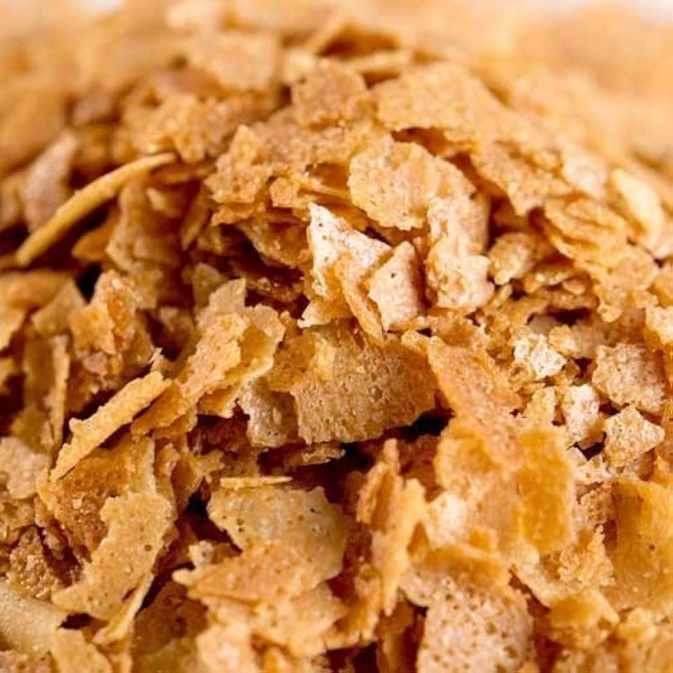 Essential Pantry feuilletine flakes bag shows crisp, golden shards ideal for crunchy dessert toppings.