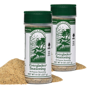 Everglades All Purpose Seasoning bottle being shaken to boost flavor on meats and vegetables.