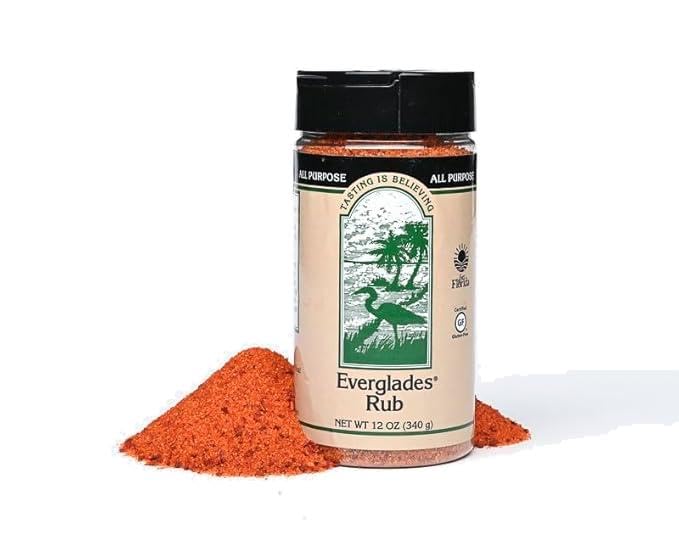 Everglades Rub Seasoning bottle being poured on meat for rich sweet-spicy flavor.