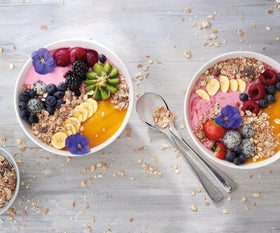 Oats, nuts, and fruit flakes in a bowl of Bircher Müesli.