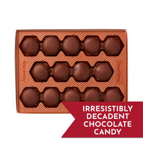 Fannie May Pixies smooth chocolate coating on glossy bites