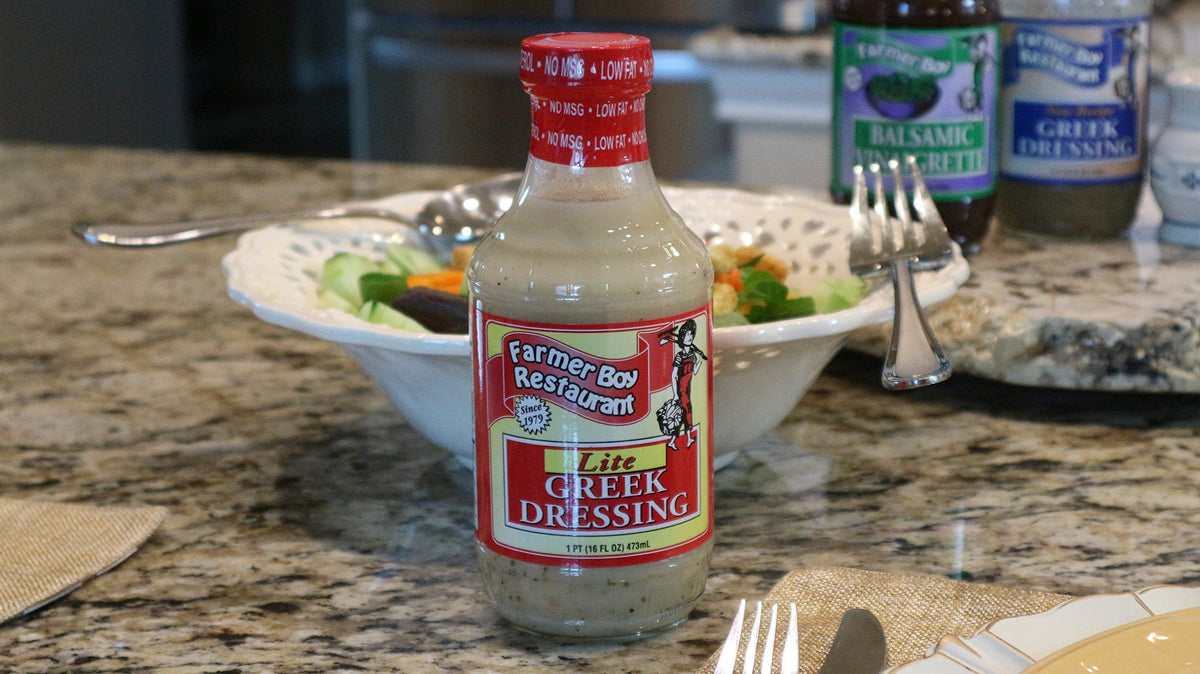 Farmer Boy Greek Lite Dressing on a colorful greens bowl for flavor