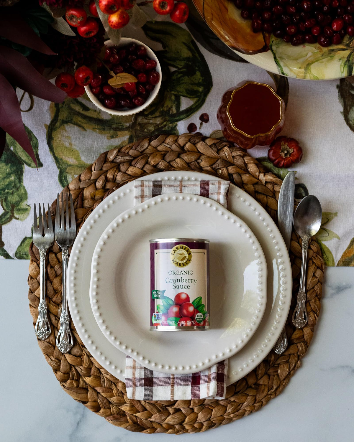 Table setting featuring FARMER'S MARKET sauce as a festive holiday side.