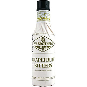 Fee Brothers Grapefruit Bitters being poured to brighten a mixed drink.