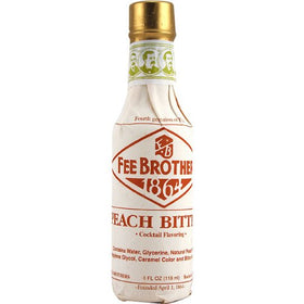 Two-pack Fee Brothers Peach Bitters on a rustic bar, ready for mixing.