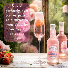 Pouring Fentimans Rose Lemonade into a tall glass with lemon zest