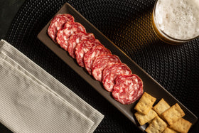 Close-up of Fermin Salchichon showing pepper and garlic seasoning.