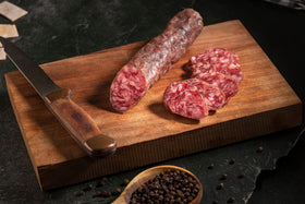 Slicing Fermin Salchichon demonstrates ready-to-serve options for hosts.