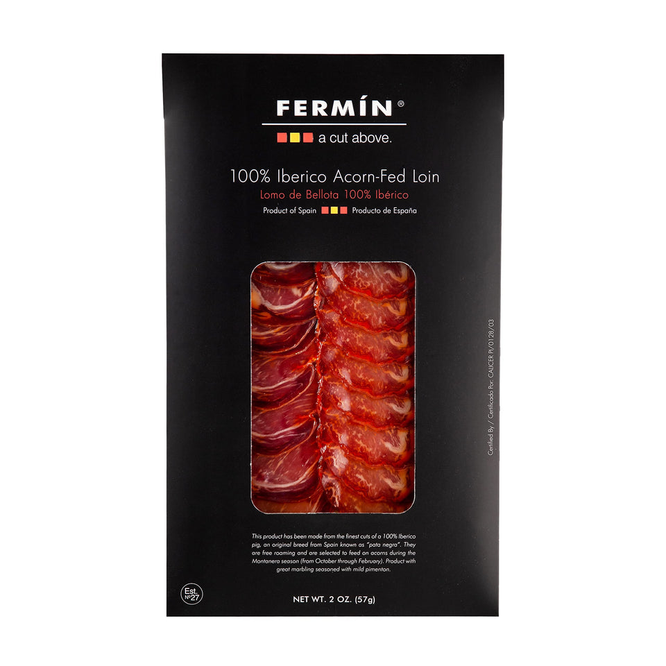 FERMIN sliced Iberico bellota pork loin 2oz on a cheese board, rich, nutty aroma ready to enjoy.