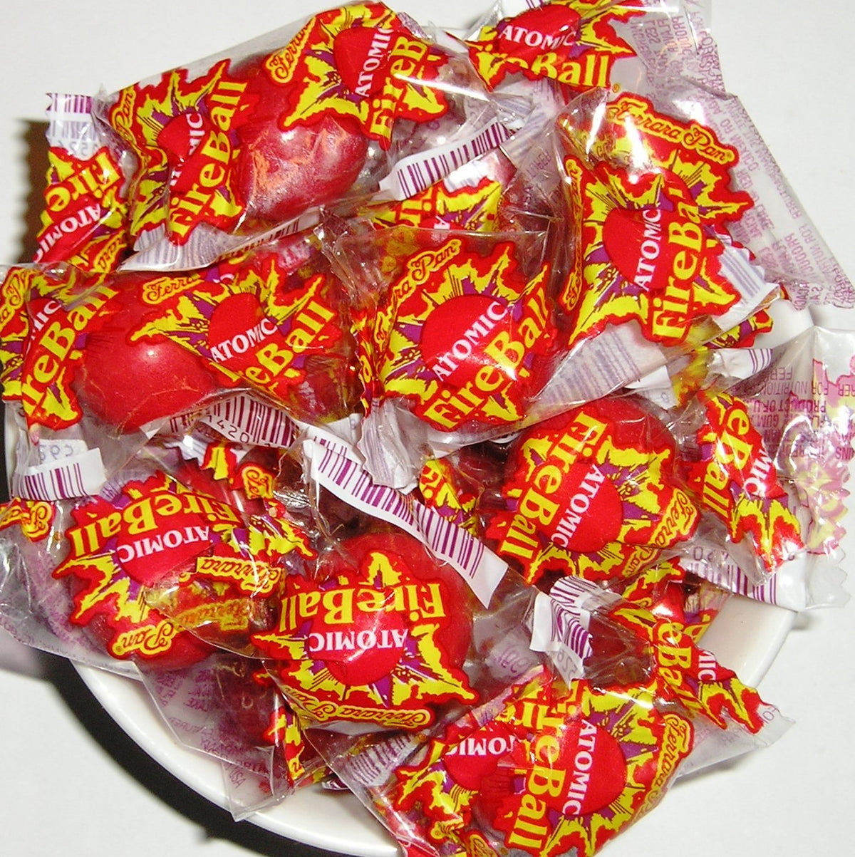Ferrara ATOMIC FireBall candies in a jar, bold heat for snack lovers.