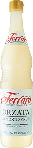 Ferrara Orzata almond syrup bottle pour, ideal for lattes and desserts.