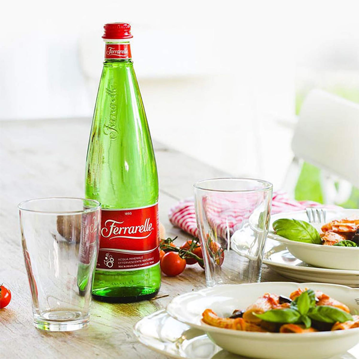 Ferrarelle glass bottle, elegant meal moment with refined effervescence.