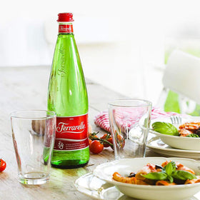 Ferrarelle glass bottle, elegant meal moment with refined effervescence.