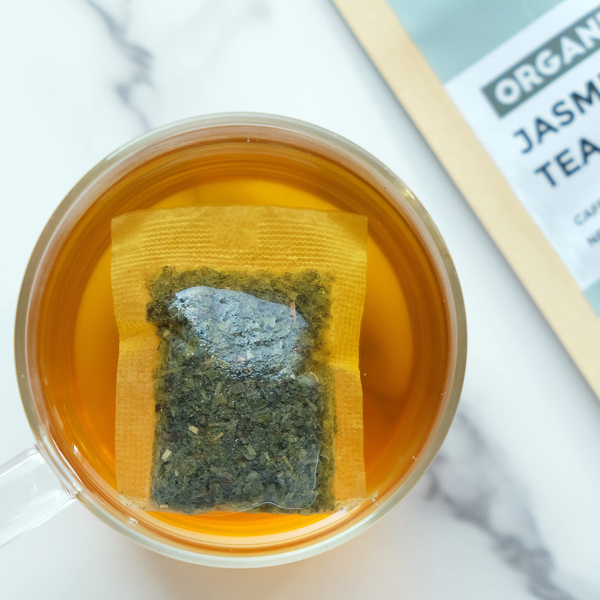 Fescha green tea in cup with steam and floral notes.
