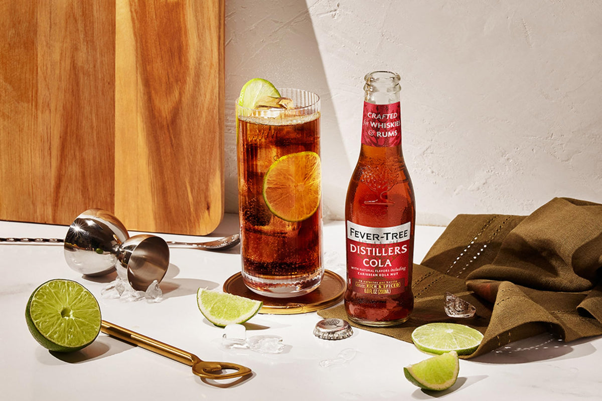 Fever-Tree Distillers Cola pour into a glass, ideal for cocktails or mocktails.