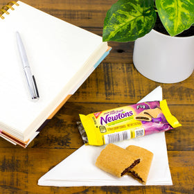 Fig Newtons original fig cookies beside coffee for a cozy pairing.