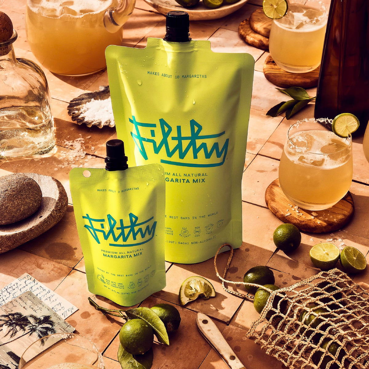 Filthy Margarita Mix being poured into a chilled glass for restaurant-quality cocktails.