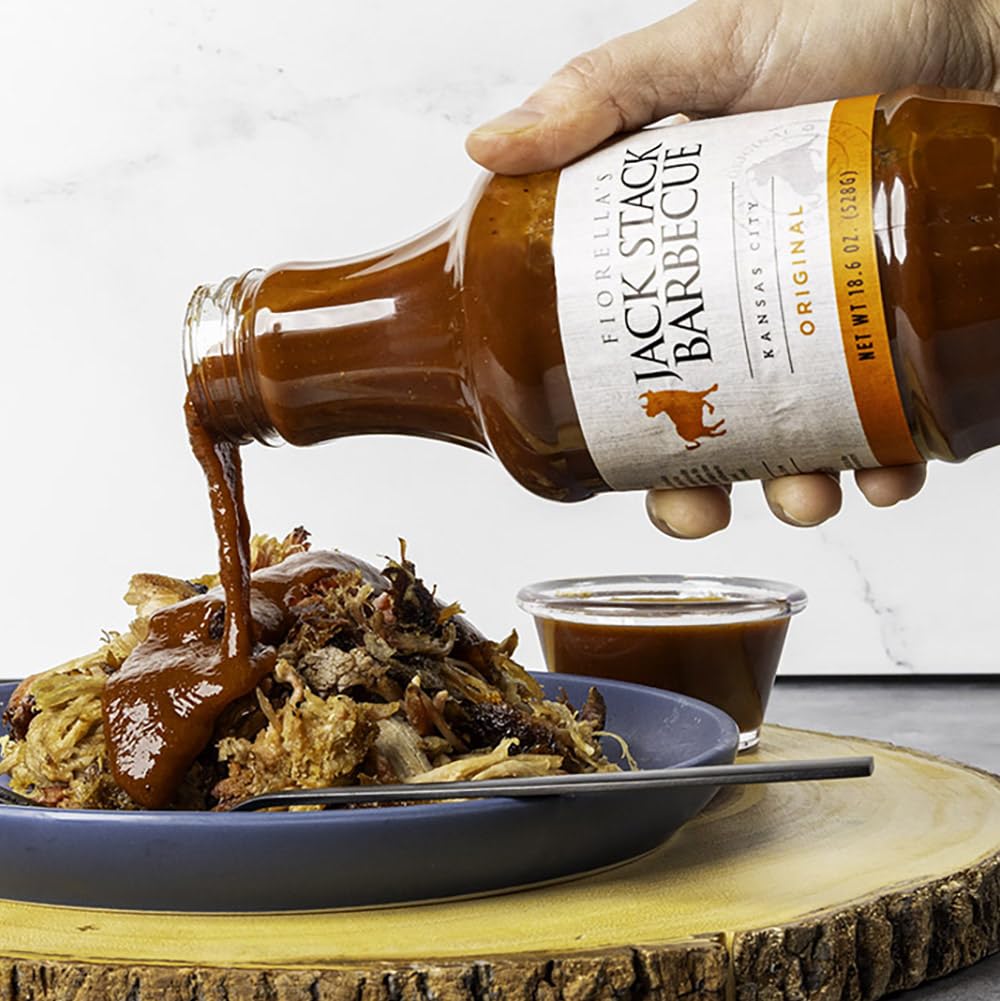 Pouring Fiorella's Jack Stack Original Sauce for glaze and marinades